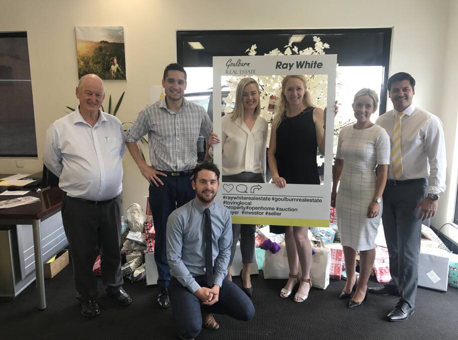 CHRISTMAS SPIRIT: (Left) Ray White Goulburn sales manager Gary Hall, sales consultant John Connell, sales consultant Jess Grashorn, Care South Goulburn representative Jennifer Toms, property manager Loren Gay, principal Justin Gay, sales coordinator Addison Gann (front).
