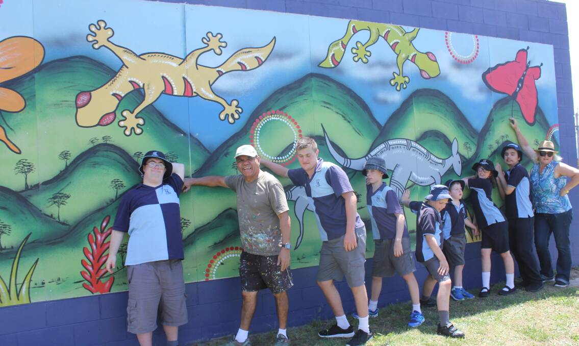 This mural is on the back of the small tennis court wall. 