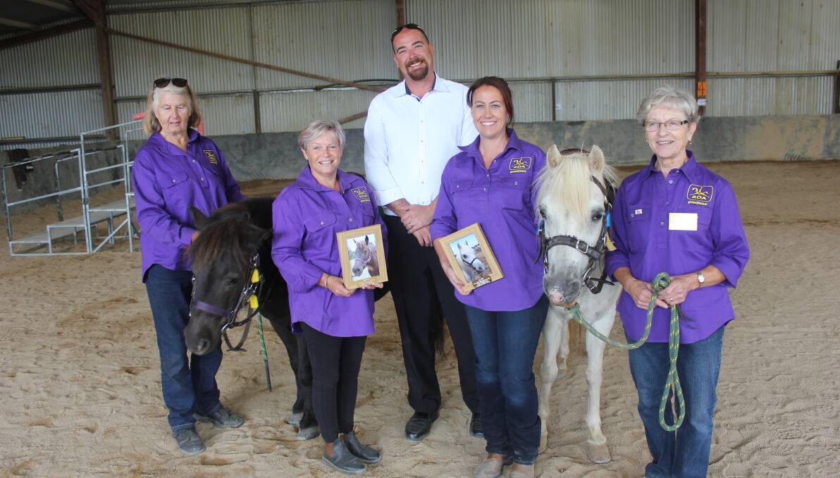 DONATION: Pat McCormick, RDA president Kerry Guyer, Paul Mewburn, coach Jo Groves and Monica Augustin with Merlin and Gypsy on Tuesday.  