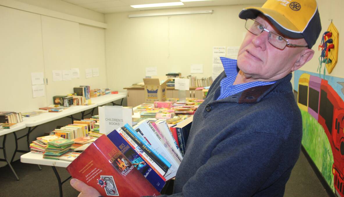 BOOKS GALORE: David Bell from Goulburn Mulwaree Rotary sorting another bundle of books for the Chairty Bookfair, which is on at Railway Cafe until October 2.