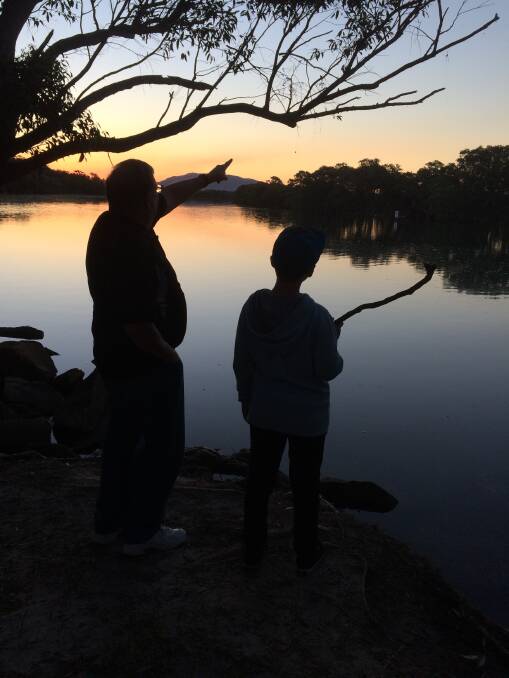PRIZE PHOTO: The photo of Bill Lambert explaining the finer points of fishing to grandson Jay Lambert, taken by Margaret Lambert. Photo: Supplied