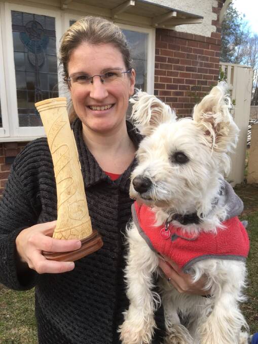 MYSTERY: Helen Hopper, Poppy and the bone carving discovered in an antique shop in Goulburn and inscribed ‘Knockaloe Isle of Man 1914-1916’. Photo supplied.
  