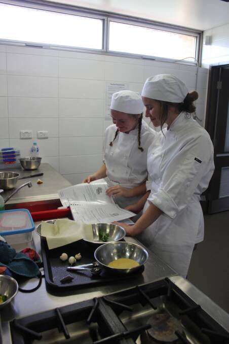 RECIPES: Chloe Meagher and Montana Sinclair-Foley were following the recipe book to create a culinary masterpiece. 