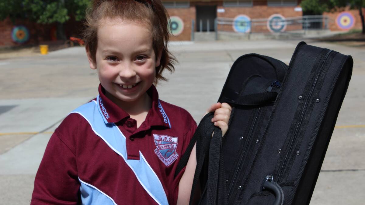 VIOLINS: Grace Mills loves her instruments and enjoys being part of the Goulburn Strings Project.