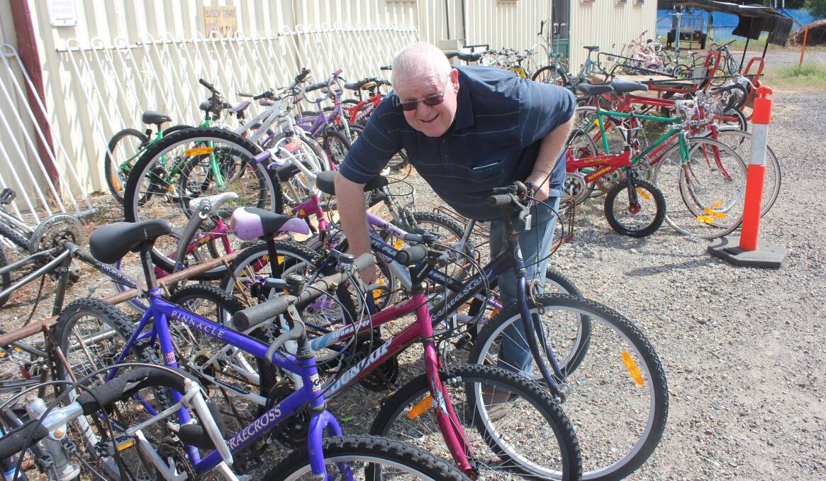 Goulburn Men’s Shed secretary Ian Marsh inspecting some of the many bikes that they repair at their premises.