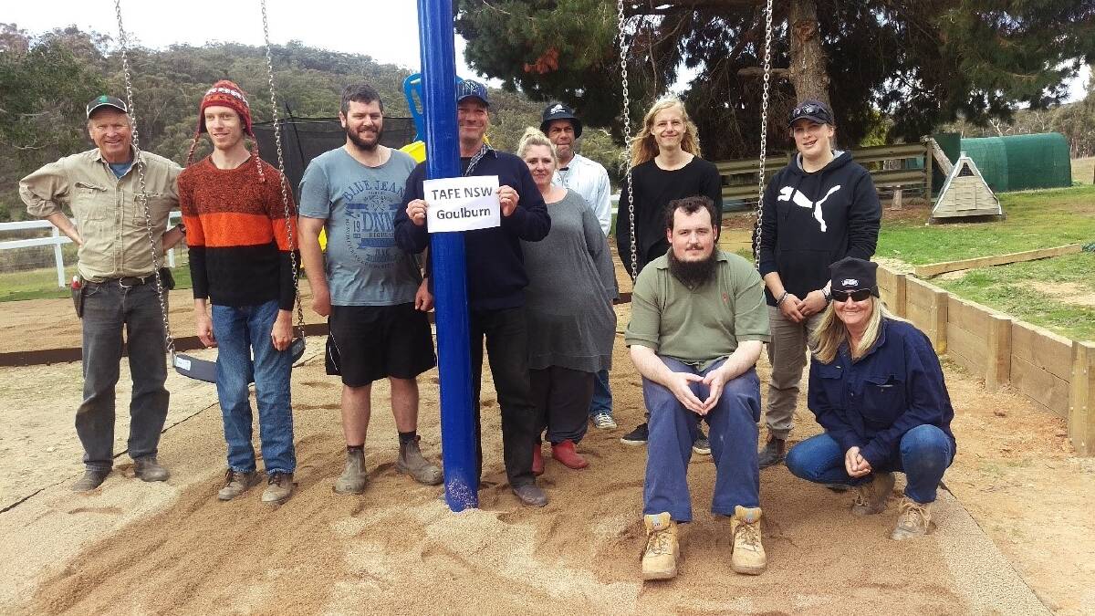NEW PLAYGROUND: Nathan Breen with the enthusiastic TAFE students and teachers who helped build him a sensory garden at his farm. Photo supplied. 