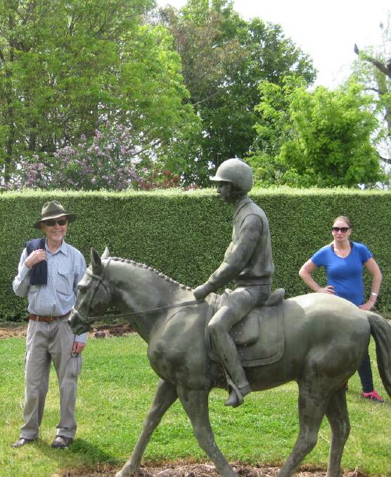 STILL LIFE: Gunning Garden Club member Bob Spiller admires the sculpture of one of John and Lyn Anderson's grandchildren during a visit to their Nanima Road garden.