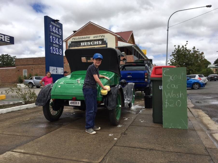 SQUEAKY CLEAN: Layla Primmer and Hal Boyce hard at work washing a Gunning Heritage Car Club vehicle at the Gunning Cubs and Scouts Fundraiser.
