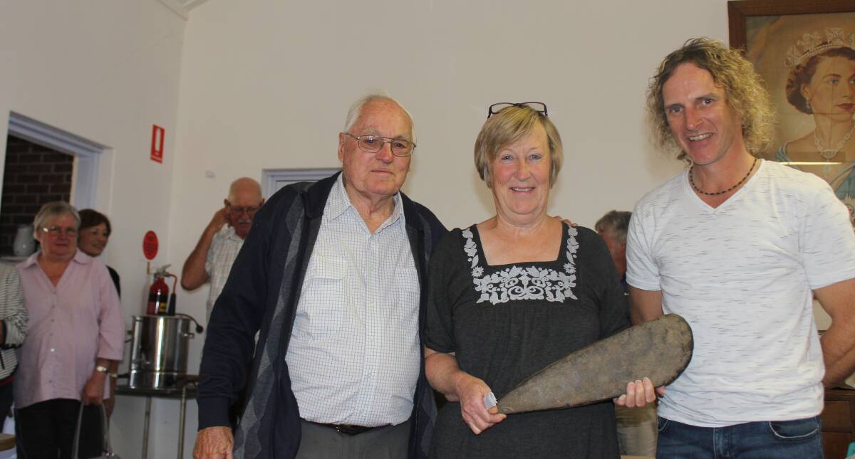 ARTEFACT: Ken Fleming, Lea Corby (holding the stone axe presented to the Historical Society by the McIntosh family) and John Menzies after the presentation. 