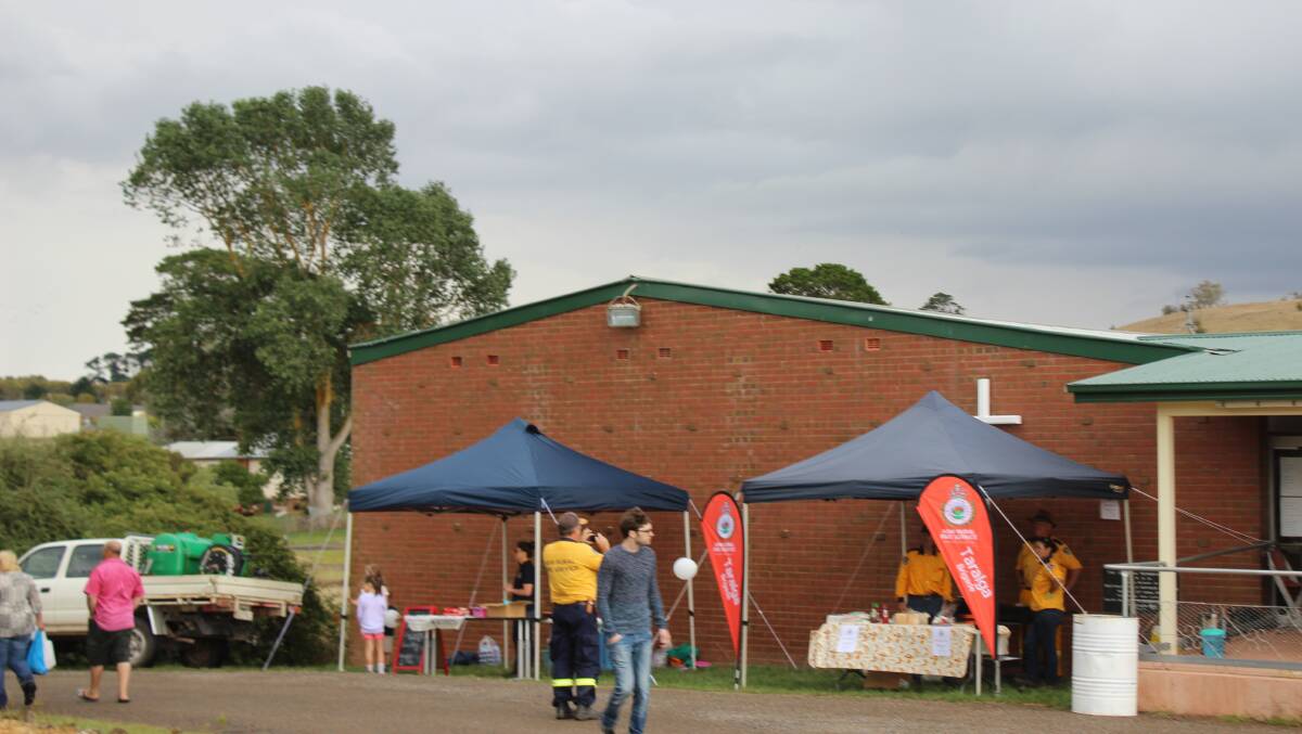 RAINED OUT: Colourful stalls were set up for the centenary fair beside Jamieson Hall before the rain came on Saturday.