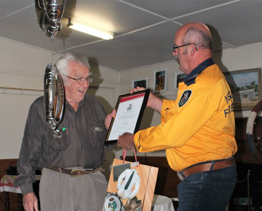 SPECIAL DAY: Albert Burman was presented with his Life Membership of Towrang Bushfire Brigade by the captain, Phillip Ohlback, on the occasion of Albert's 90th birthday celebration in January. Photo: courtesy of J Mason.