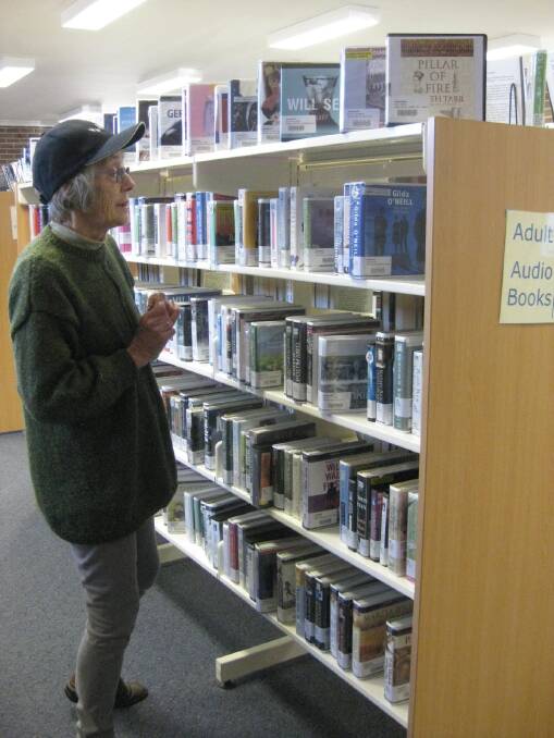 RESEARCH: Sue Walker, off soon to volunteer in Myanmar, pictured checking out the audio books at the Gunning Library.