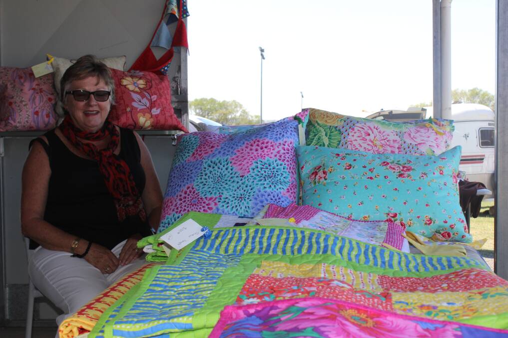 COLOURFUL: Carmel with some of the beautiful quilts that were displayed at this year's Taralga Show.