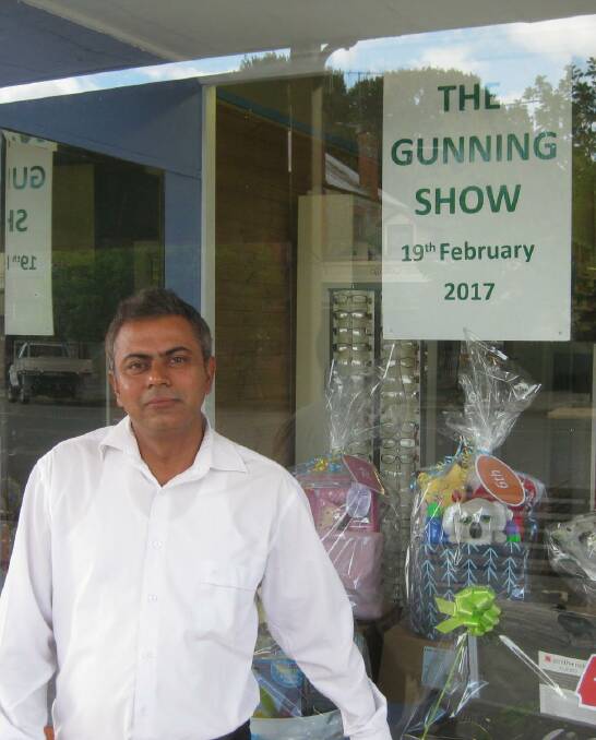 FINGERS CROSSED: Gunning pharmacist Jaideep Sharma was happy to help by displaying Gunning Show raffle prizes in his shop window.
