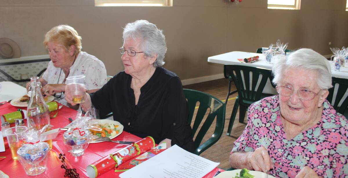 SEASONAL: Cathy Webb, Mary Halkett and Thelma McPaul enjoyed the traditional Christmas lunch cooked and presented by the Progress Association.