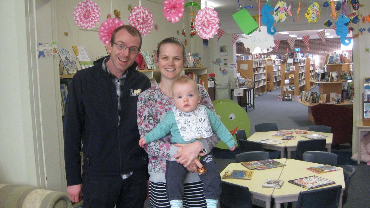 NEW FRIENDS: New residents Peter McKinlay, Brianna Reeve and 10 month old son Fletcher check out Gunning Library.