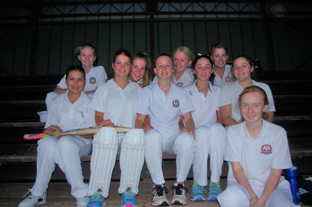 GILLIGAN'S GIRLS: Most of the Goulburn United under 14 girls' cricket team sheltering from the storm in the Seiffert Oval grandstand on Saturday. Photo: Darryl Fernance