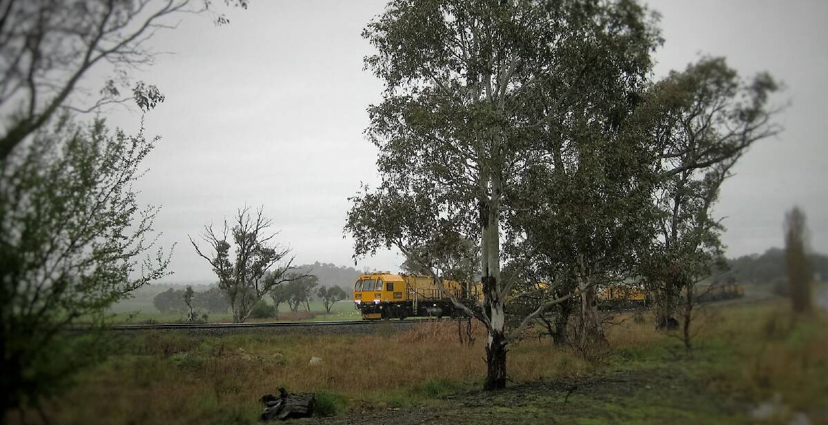 RAILLY CLEVER: Aurizon track maintenance crew working in the pouring rain, ideal weather for a task where sparks from grinding sometimes start fires.
