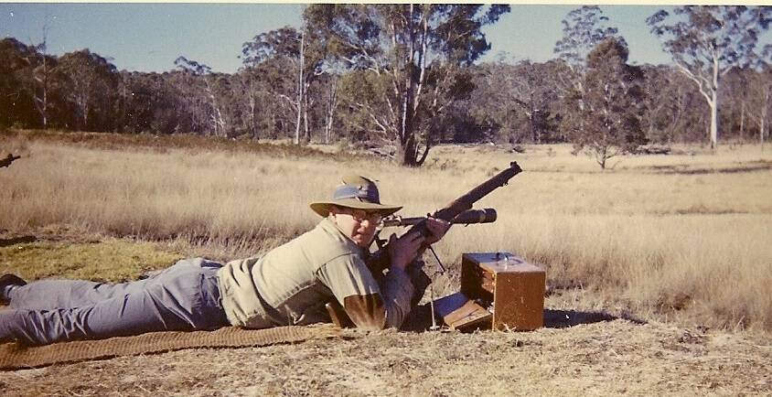IN HIS SIGHTS: T Pearson, former manager of Blue Circle Marulan South, with the Rifle Club at rear. The club provided a social focus for the town. Photo: supplied