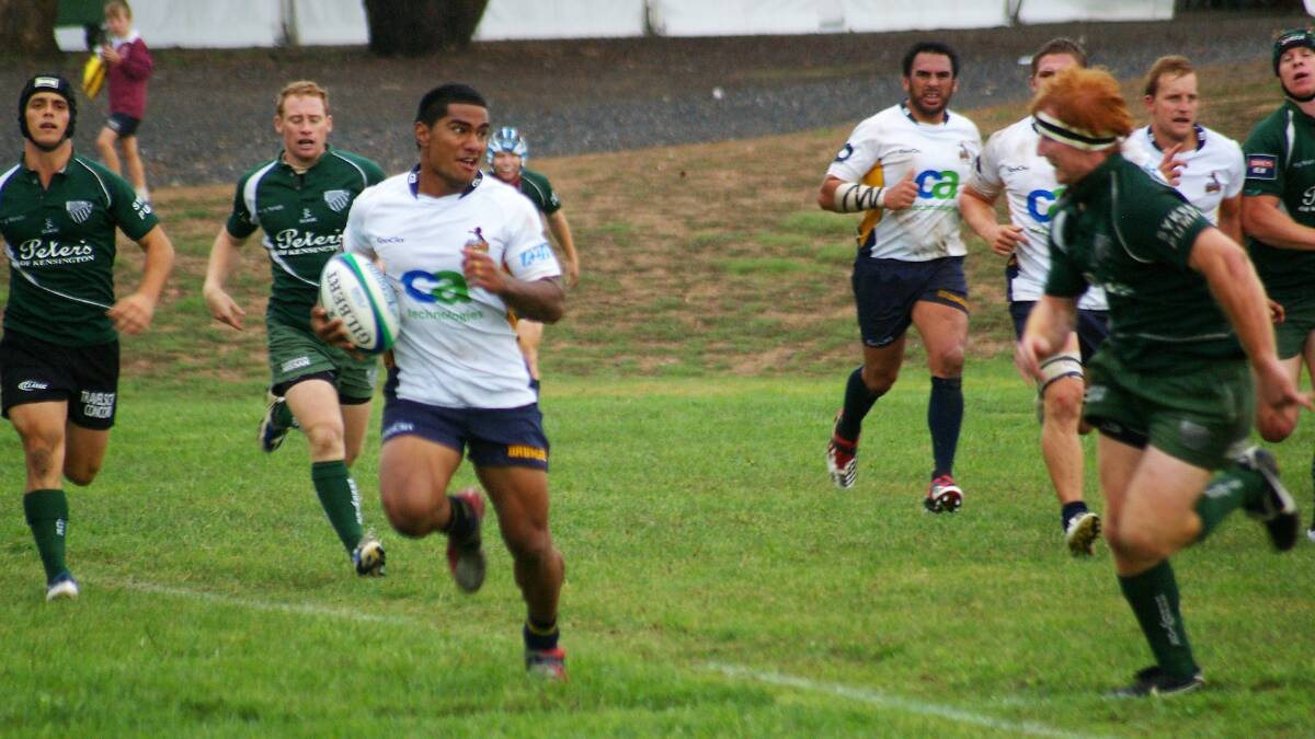  IN THE CLEAR: A Brumbies Runner player makes a break as a Randwick defender looms toward him at Poidevin Oval in 2011. Photo: Chris Gordon