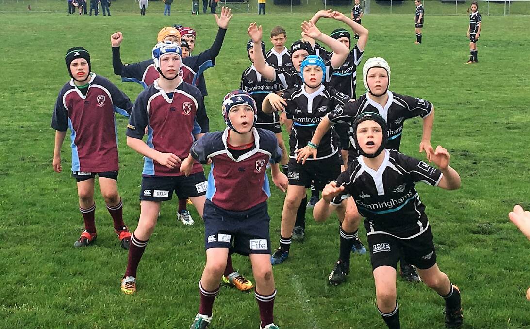 EYES ON THE BALL: Goulburn Fizzy Reds under 12 development players (left) contesting a line out during their game against Seaforth Raiders on Poidevin Oval on Sunday. Photo: supplied