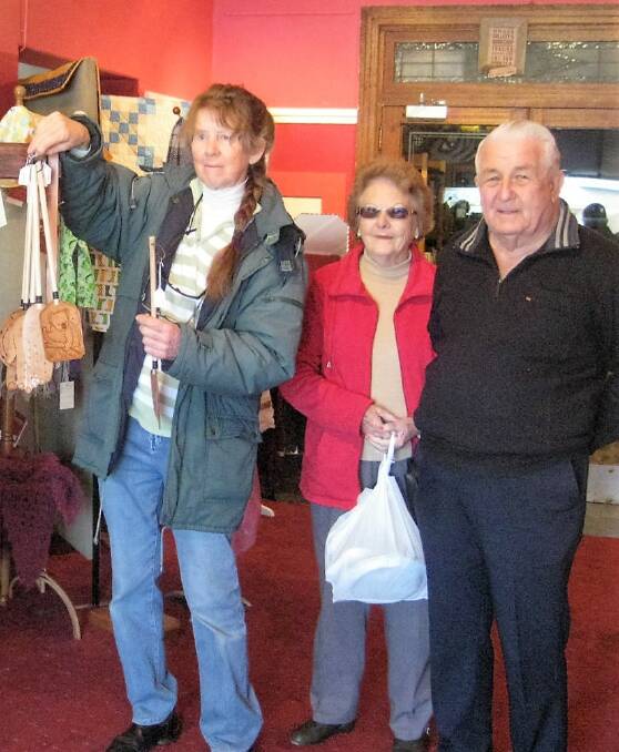 Gunning Lions Markets: Beryl Skinner of Creative Gunning chatted with Crookwell visitors Pat and Ken Bott at the organisation's new main street shopfront.