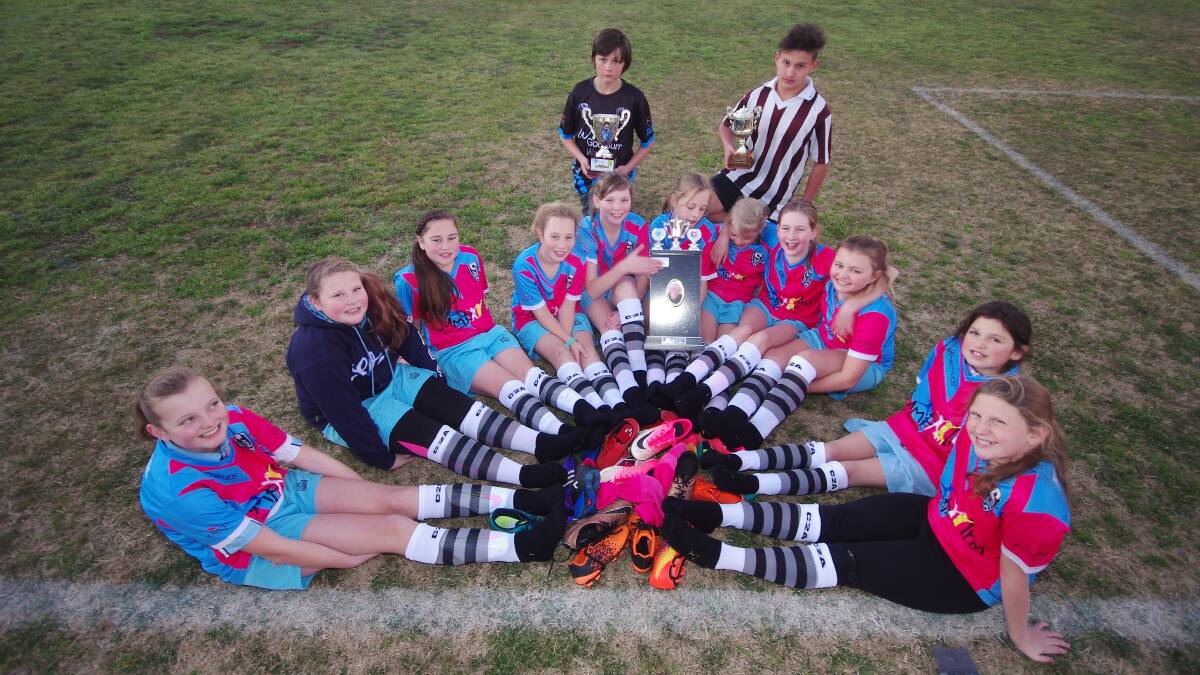 Caleb Channel (Stags) with the Call to Arms Cup; William Fernance (MBK) with the Bradley Chisholm Cup; Breanna Norris with the Phil Patton Shield; and Stags' white u10 girls with Call to Arms/Love Your Sister socks.