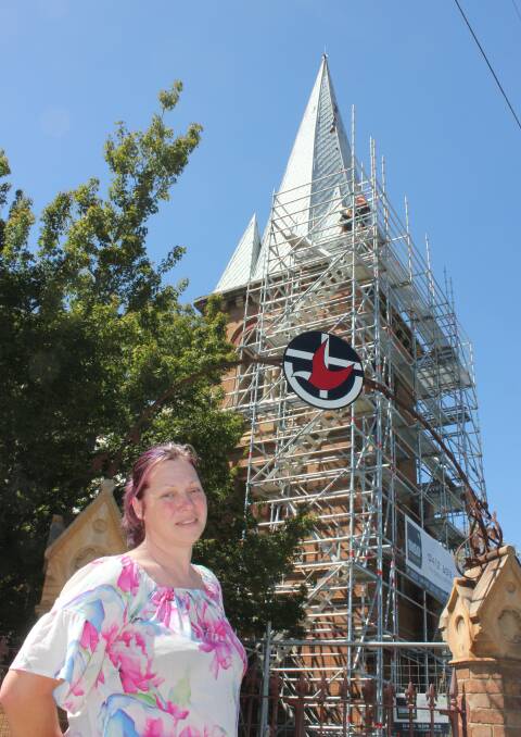 ONWARDS AND UPWARDS: Reverend Julie Lawton-Gallard in front of the damaged historic Uniting Church steeple in Goldsmith Street on March 16. Photo: David Cole
