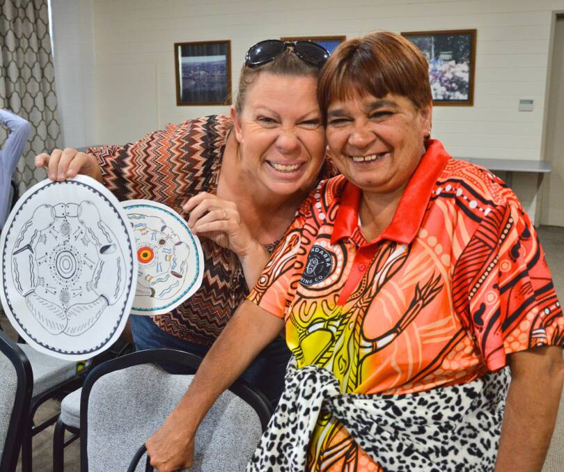 Artist Jodie Munday talking to Committee Member Veronica Ford about the different versions of the logo for the Mulwaree Aboriginal Community. Picture supplied.