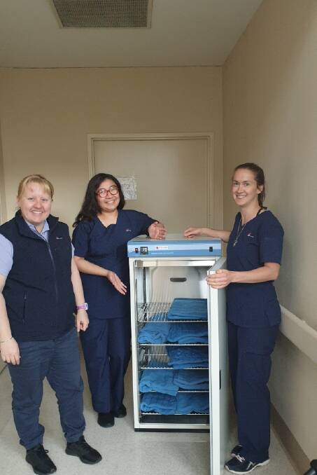 Oncology staff with the blanket warmer: Josephine Kennedy, Kathrina Legaspi, and Anna Gray. Picture supplied.