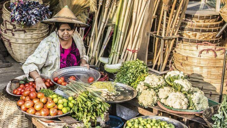 A woman sells vegetables on the market of Mawlamyine, Myanmar.