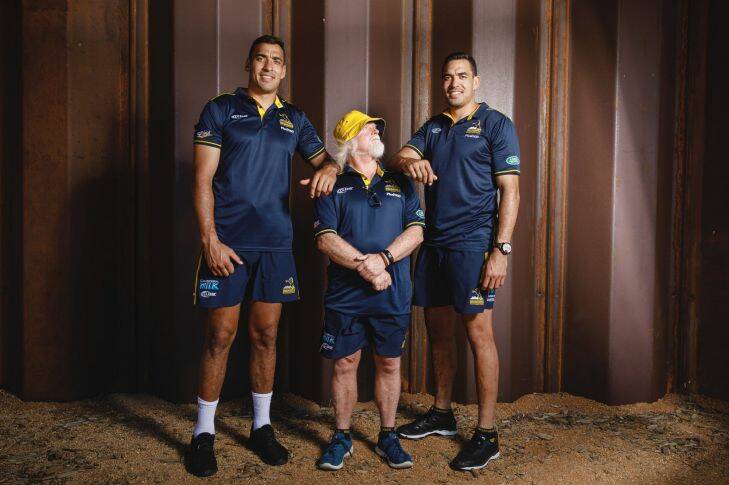 Brumbies forwards coach Laurie Fisher measures up against twins Richie and Rory Arnold. Photo: Sitthixay Ditthavong
