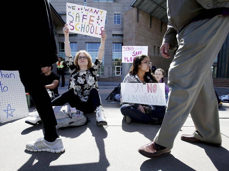 High school juniors Ella Dunkle, left, and Samantha Zazueta sit in silent protest Tucson, Arizona.