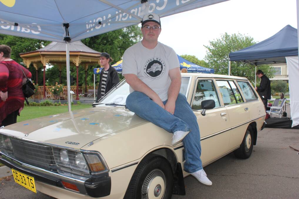3000KM OF FUN(DS): Corey McAlister sits on the bonnet of his 1979 Chrysler Sigma station wagon, bought for only $500 on eBay. Photo: Antony Dubber
