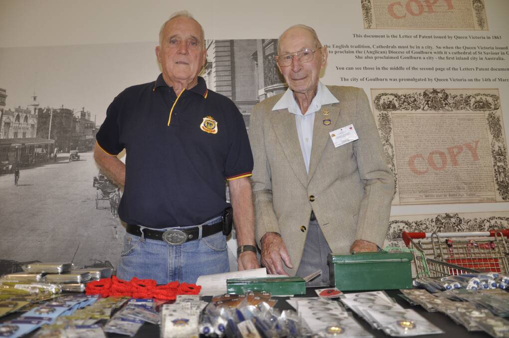 SERVICE: Goulburn RSL Sub Branch president Gordon Wade and co vice-president Lance Cooke selling Anzac Day merchandise this week.  
Photo: Louise Thrower
