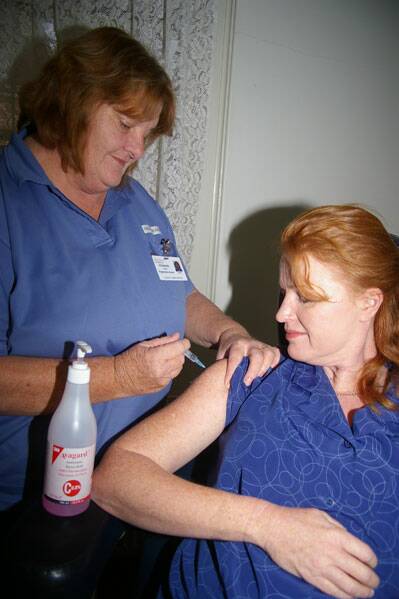 VIGILANT: Goulburn Base Hospital infection controller clinical nurse specialist (CNS 2) Liz Taylor administers a tetanus, diphtheria and whooping cough booster to enrolled nurse Dianne Van Essen recently.