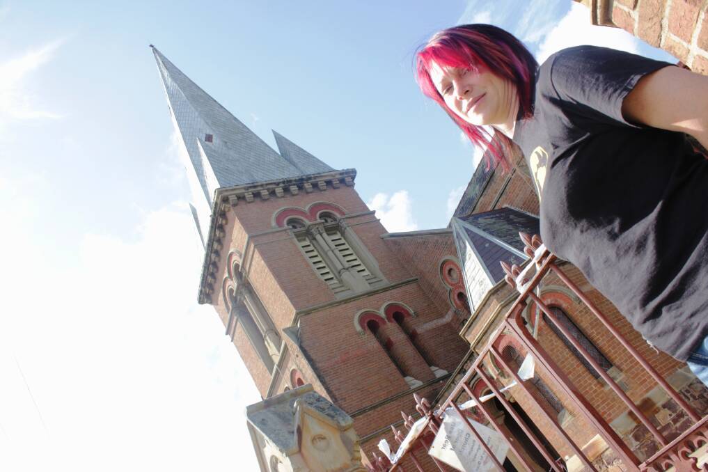 STEEPLE: Reverend Julie Furner surveys the damage to the Uniting Church steeple last year.