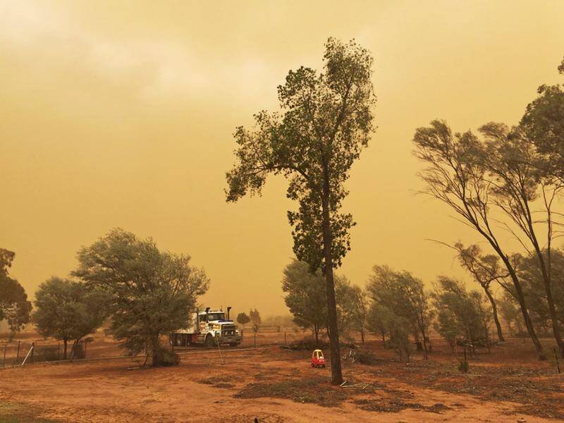 An outback Queensland town has been covered by dust in a storm that turned the sky orange.