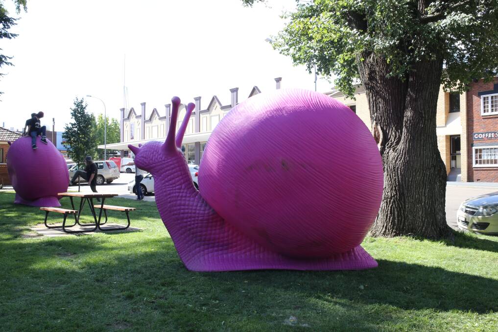 PUBLIC ART: A pair of giant pink snails will reside in Belmore Park for the next few months.