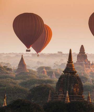 Hot air balloon over plain of Bagan in misty morning, Myanmar Mawlamyine.