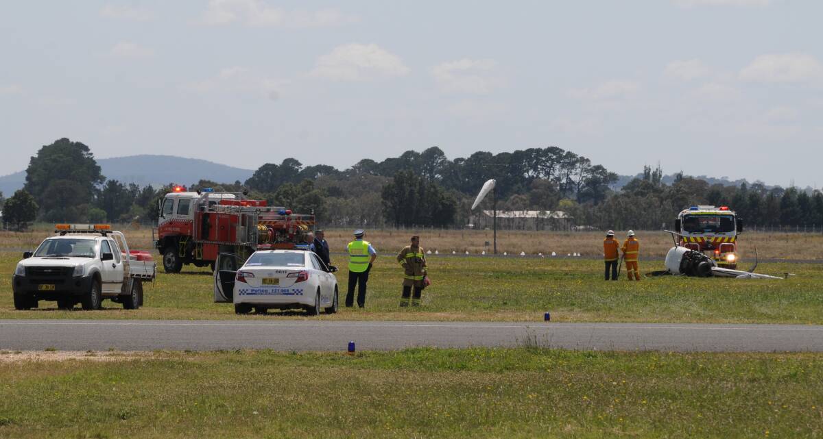 LUCKY ESCAPE: A woman and her flying instructor escaped serious injury when their helicopter crashed at Orange airport yesterday morning. Photos: OLIVIA SARGENT