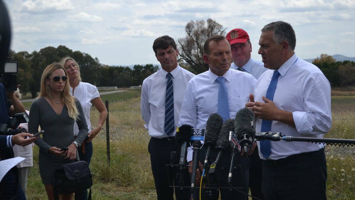 Angus Taylor with Prime Minister Tony Abbott, Treasuer Joe Hockey and Minister for Agriculture Barnaby Joyce (in cap) at the announcement at Murrumbateman. Photo Jessica Cole, Yass Tribune.