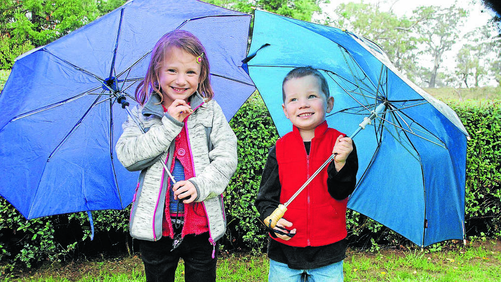 COOMA: Zara and Zac Zigic of Jindabyne enjoy 'Mia Mia' as part of the Nimmitabel Garden Club Open Gardens Day on a rainy Saturday. n More photos from the Open Gardens Day on Page 10.