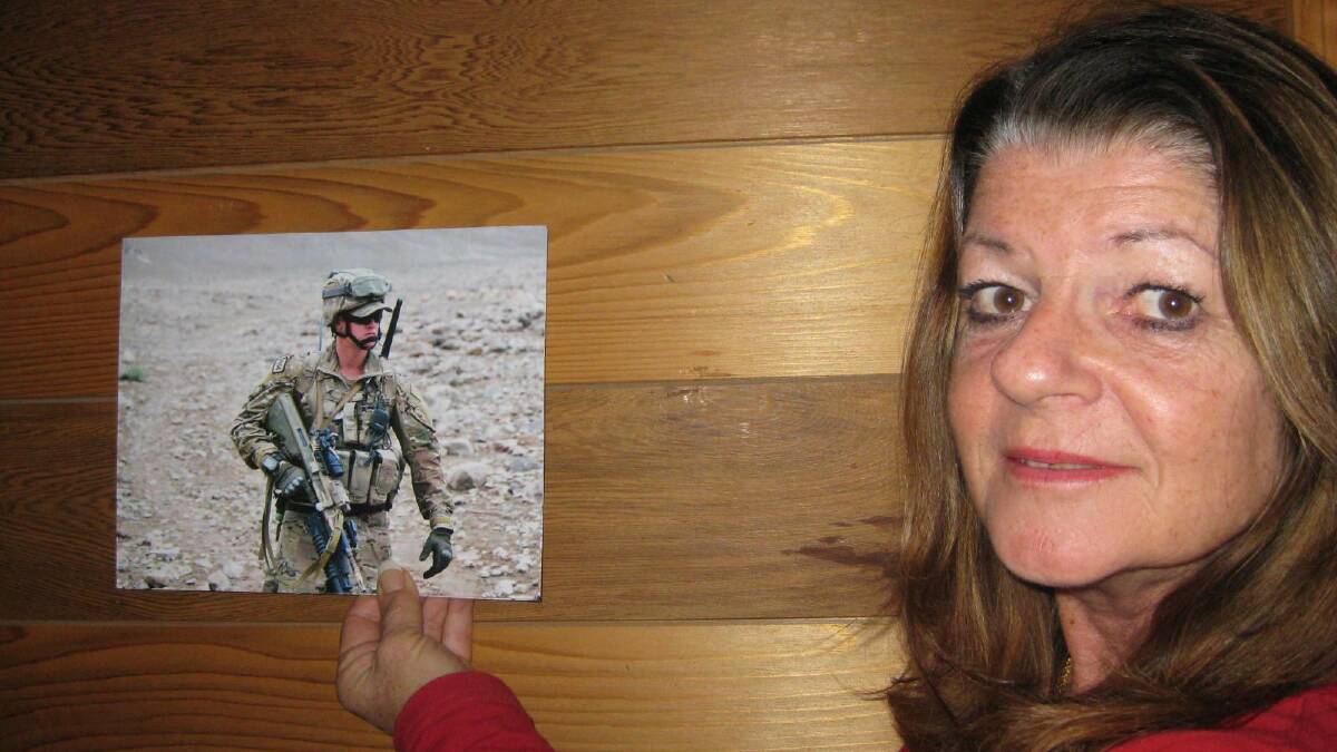 Carol Sharp, with a photo of her son, Matt. Photo supplied