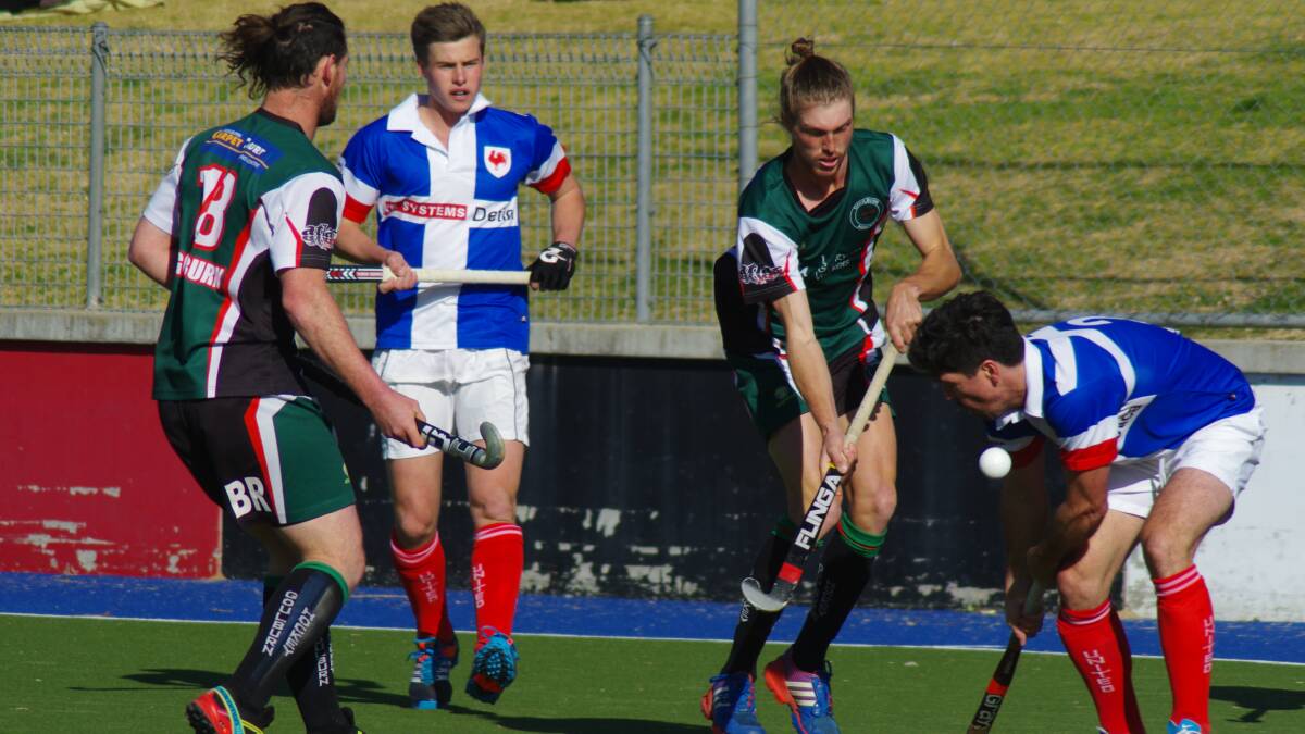 Dean Robertson is pressured by United’s Iain Davidson (right) during the early part of the game as Gecko’s Blake Robertson (left) comes across in support.