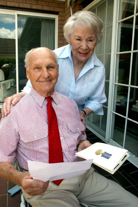 GRAND PARTNERSHIP: Ray Leeson with his “best cadet,” wife Pat upon receiving his Order of Australia Medal in 2008 for services to the newspaper industry
and the community. It added to a long list of awards for the Goulburn Post’s longest serving editor, who died on Friday. Photo: Leon Oberg.