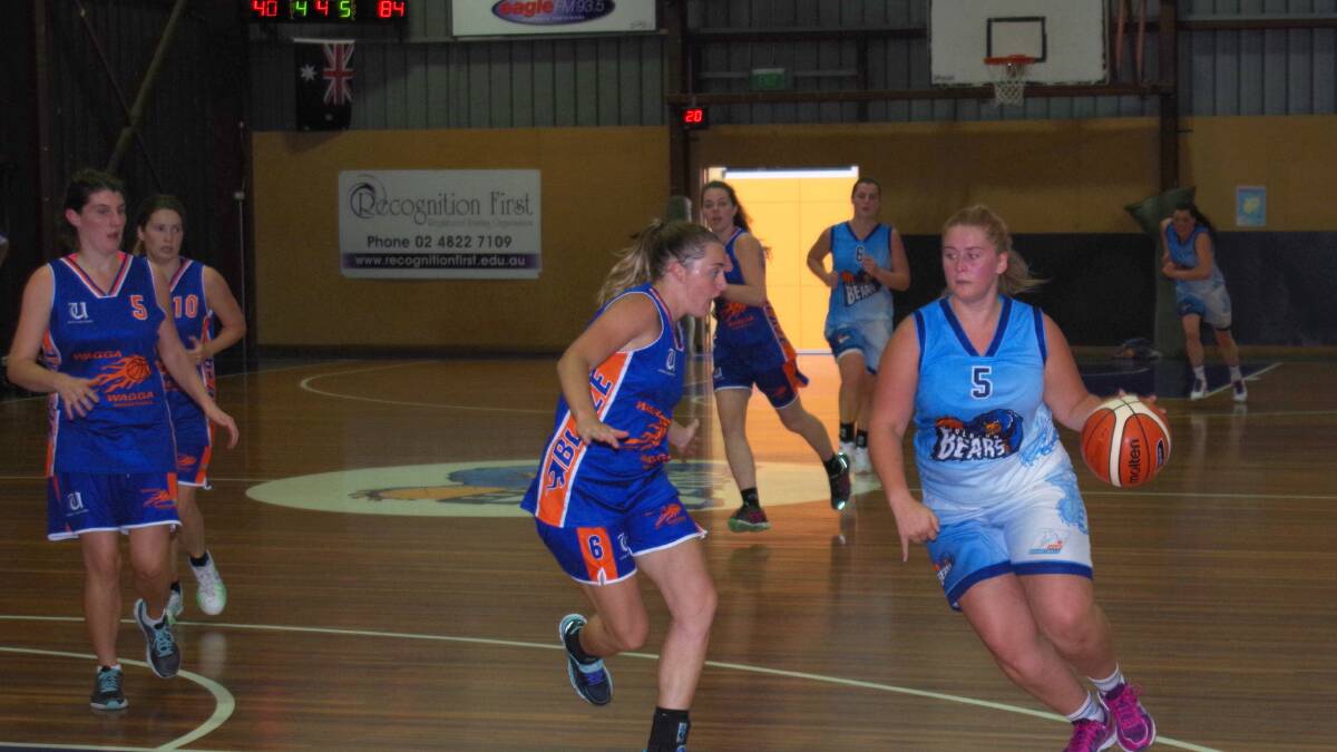 LOOKING TO SHOOT: Paige Penning takes the ball into the circle to attempt a layup shot guarded by Wagga Blaze’s Prue Walsh during the clash at the Goulburn Bearpit on April 16. Photo: Darryl Fernance. 