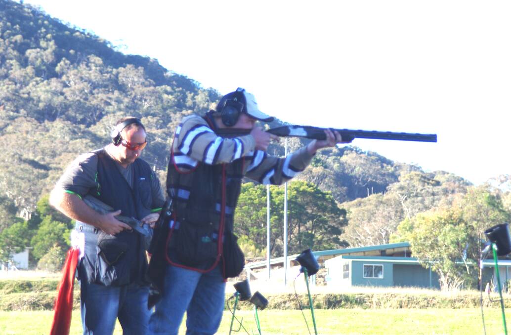 COMPETING: Cooper Mooney shooting, with eventual winner of the Continental competition at Sunday’s meeting at the Goulburn Clay Target Club range, Justin Smith of Boorowa, reloading behind. Photo Darryl Fernance 
