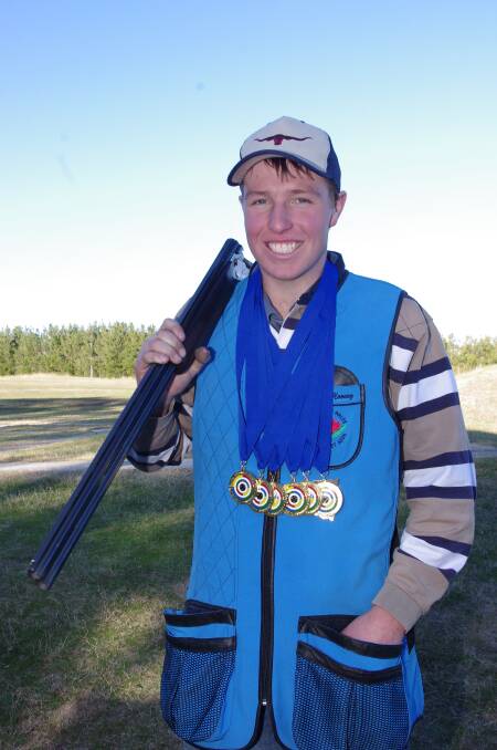 THAT'S GOLD: Cooper Mooney with his six gold medals won in New Zealand as a member of the Australian Clay Target Association Junior Team. Photo: Darryl Fernance. 