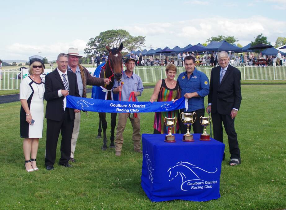 CONGRATULATIONS: Sponsors Lyn and David Alt, part owner Mike Walcott, Just a Blur, strapper John Bishop, trainer Barbara Joseph and Paul Jones with Goulburn and District Racing Club president Fred Cooper. (Photo by Darryl Fernance.)